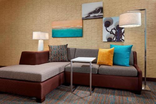 a couch with colorful pillows in a room at Residence Inn by Marriott San Diego Chula Vista in Chula Vista