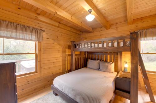 a bedroom with a bunk bed in a log cabin at Creekside Bryson City Cabin with Private Hot Tub in Bryson City