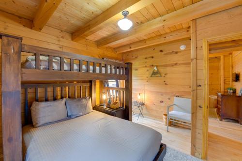 a bedroom with a bunk bed in a log cabin at Creekside Bryson City Cabin with Private Hot Tub in Bryson City