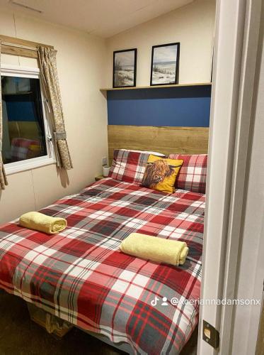 a bedroom with a bed with two pillows on it at Presthaven Sands in Prestatyn