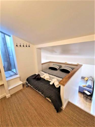 Ένα ή περισσότερα κρεβάτια σε δωμάτιο στο Appart lumineux de l'Hôtel de Ville