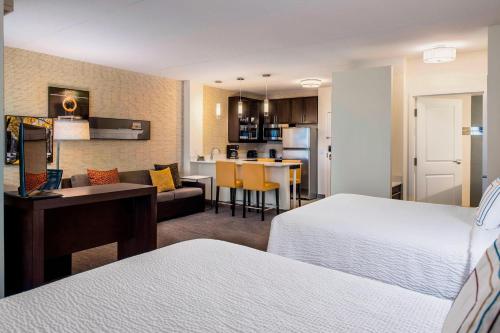 a hotel room with two beds and a kitchen at Residence Inn by Marriott Regina in Regina