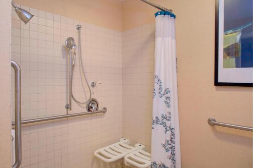 a bathroom with a shower and a toilet at Residence Inn by Marriott Richmond Chester in Woodvale