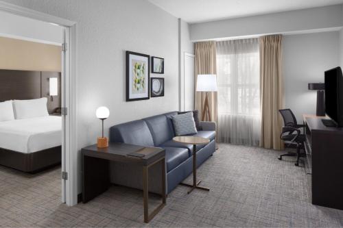 a hotel room with a bed and a couch at Residence Inn Tampa Oldsmar in Oldsmar