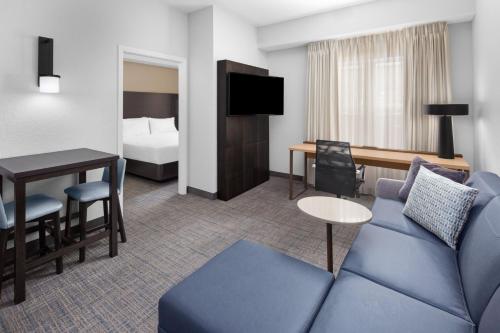 a hotel room with a couch and a bed at Residence Inn Tampa Oldsmar in Oldsmar