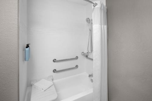 a bathroom with a tub and a shower with a toilet at Residence Inn Tampa Oldsmar in Oldsmar
