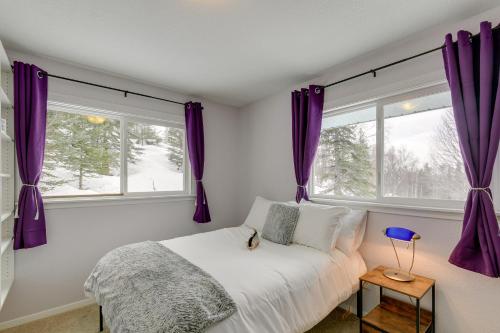 a bedroom with purple curtains and a bed with a window at Cozy Anchorage Vacation Rental with Deck, Gas Grill in Anchorage