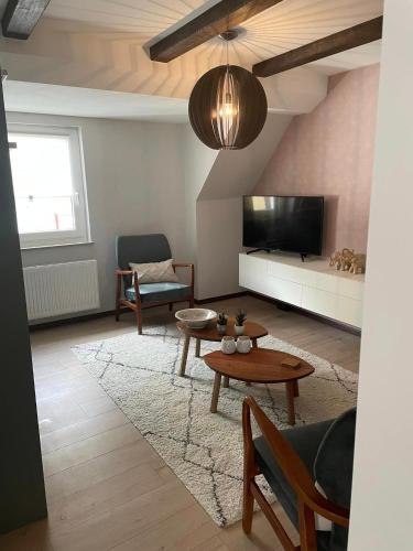 a living room with a couch and a tv at Excellent house in Ediger-Eller