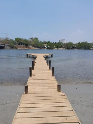 a wooden pier stretches out into the water at PLAYA MAG in Coveñas