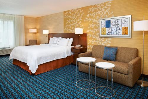 a hotel room with a bed and a couch at Fairfield Inn by Marriott Port Huron in Port Huron