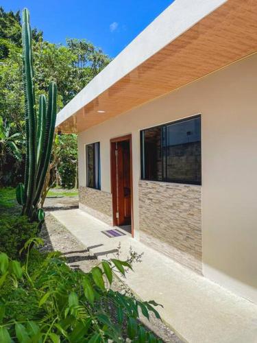 a house with a cactus in front of it at La Fortuna Donwtown Dreams in Fortuna
