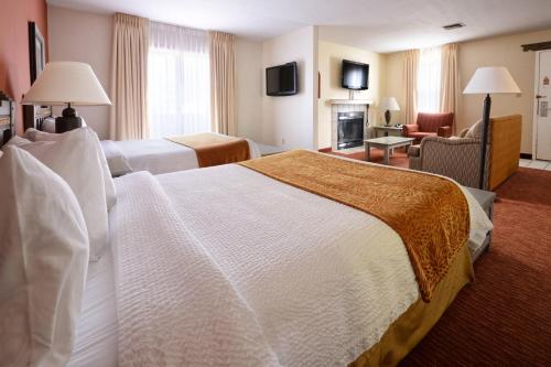 a hotel room with two beds and a fireplace at Residence Inn Santa Fe in Santa Fe