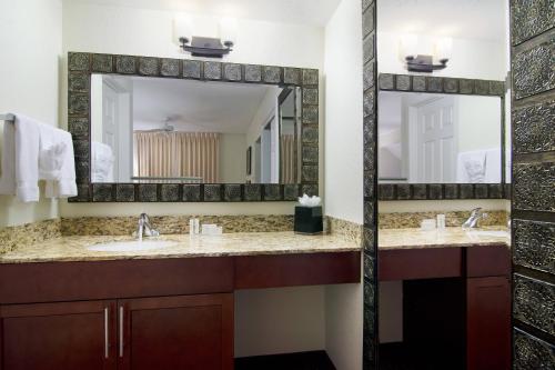 a bathroom with two sinks and a large mirror at Residence Inn Santa Fe in Santa Fe