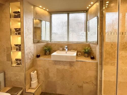 a bathroom with a sink and a shower at The Barn At Woodland View in Barlow