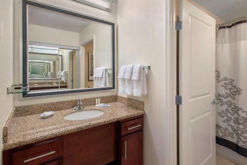 a bathroom with a sink and a mirror at Residence Inn Alexandria Old Town South at Carlyle in Alexandria