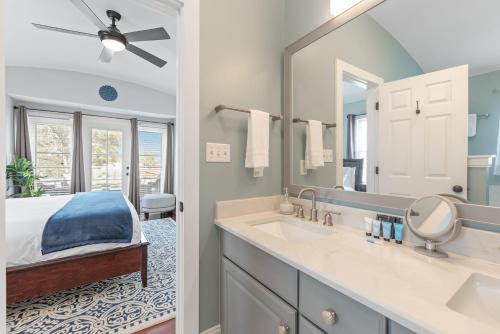 a bathroom with a bed and a large mirror at Rooftop Deck with Parking - 3 Blocks to KING in Charleston