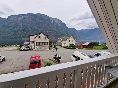a balcony with a view of a parking lot and mountains at Undredal Fjord Apartments in Undredal