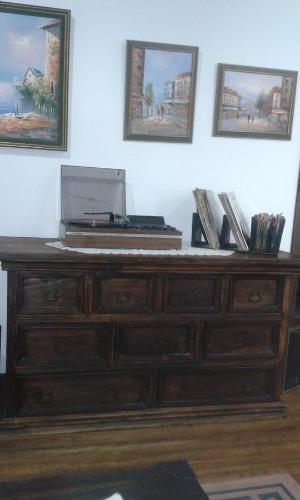 a wooden dresser with a laptop on top of it at Hostel Camelot Salento in Salento