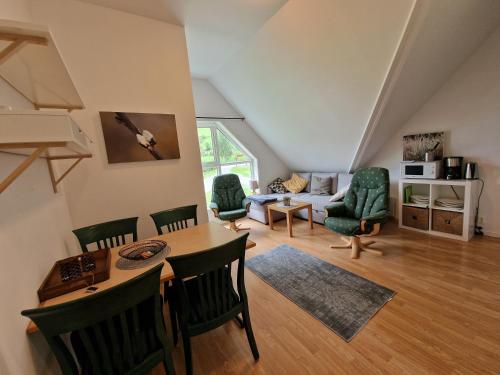 a living room with a table and chairs at Undredal Fjord Apartments in Undredal