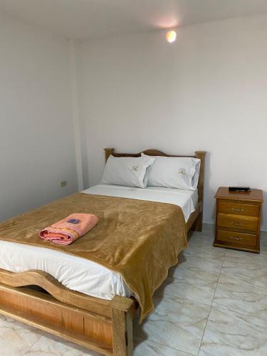 a bedroom with a large bed with a wooden frame at Hotel la Victoria in San Roque