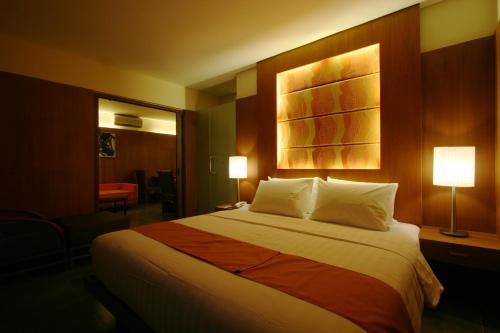 a hotel room with a large bed with two lamps at Crown Regency Beach Resort in Boracay