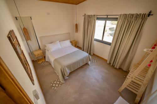 a small bedroom with a bed and a window at Complejo Los Olivos - casa 3 y 4 in Cafayate