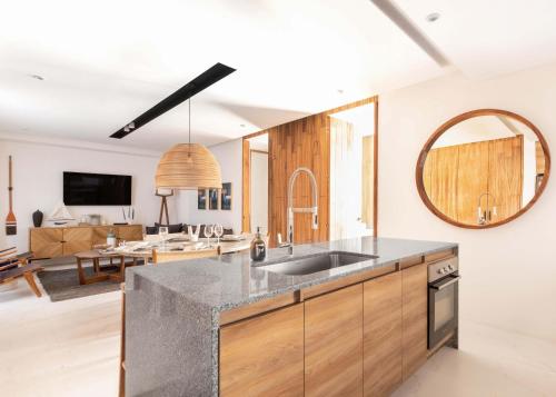 a kitchen with a sink and a living room at Mako 54 in Puerto Vallarta