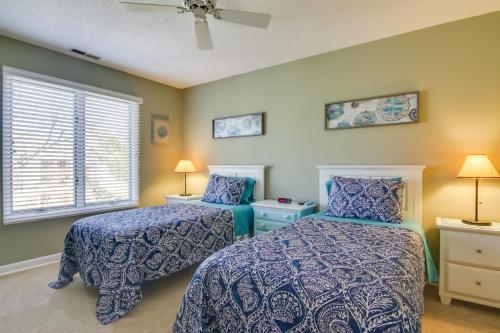 a bedroom with two beds and a window at Condo with 2 Balconies and 3 Pools Less Than 2 Mi to Beach! in Rehoboth Beach