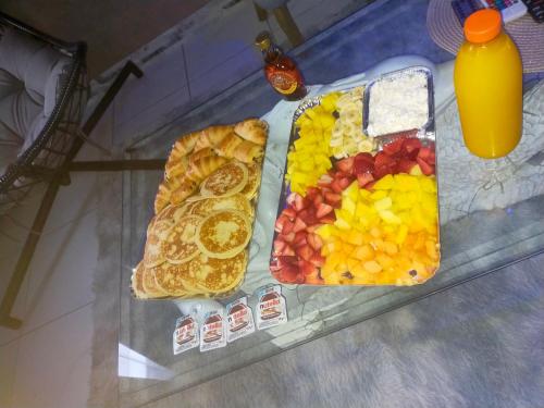 a glass table with a tray of fruit and breakfast food at Love Paradise by Karen's Room Service in Forbach