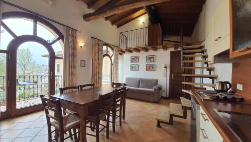 a kitchen and dining room with a table and chairs at Villa Santa Caterina in Manerba del Garda