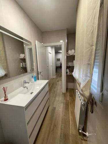 uma casa de banho com um lavatório branco e um espelho. em Apartamento Centro de Jaén em Jaén