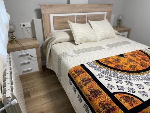 een slaapkamer met een bed en een nachtkastje met een bed sidx sidx bij Apartamento Centro de Jaén in Jaén