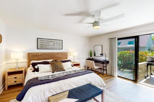 a bedroom with a bed with a ceiling fan and a piano at Queens Grant 684 in Hilton Head Island