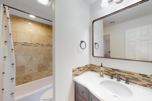 a bathroom with a sink and a mirror at Queens Grant 684 in Hilton Head Island