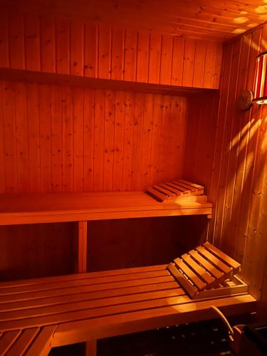 a wooden sauna with a wooden bench in it at Doppelzimmer Nr 4 in Freiensteinau
