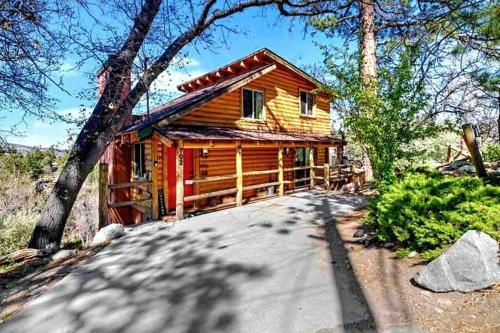 a log cabin with a driveway in front of it at Cozy Moon Cabin in Big Bear Lake