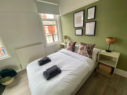 a bedroom with a large white bed with two pillows on it at Manchester House in Blackpool