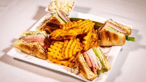 a plate of food with a sandwich and french fries at Magnuson Grand Harrisburg in New Cumberland