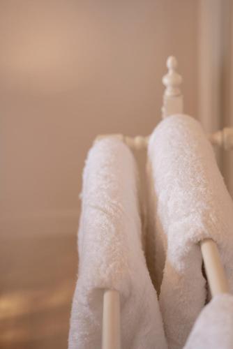 a group of white towels sitting on top of a crib at The Castle in Greytown