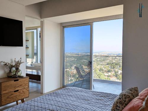 a bedroom with a bed and a large glass window at Luxury Condo in Lobby33 near Andares By Bamboo in Guadalajara