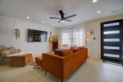 a living room with a couch and a ceiling fan at Prickly Pear at Cactus Flower-Private HOT TUB-Pet Friendly-No Pet Fees! in Albuquerque