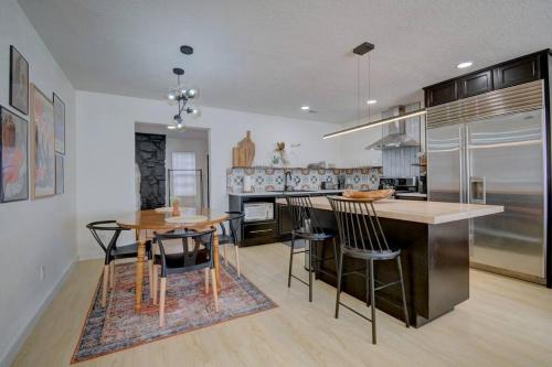 a kitchen with a table and chairs and a counter at Prickly Pear at Cactus Flower-Private HOT TUB-Pet Friendly-No Pet Fees! in Albuquerque