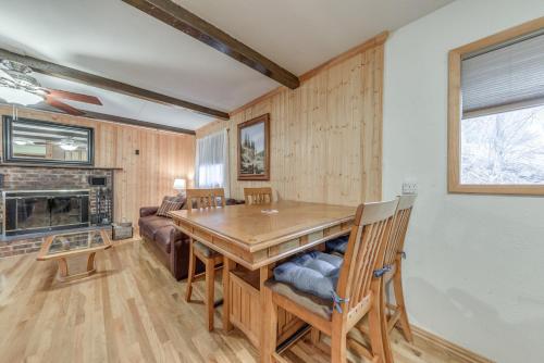 a dining room with a table and a fireplace at Cloudcroft Cabin Vacation Rental 3 Mi to Skiing! in Cloudcroft
