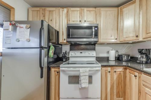 a kitchen with a white refrigerator and a microwave at Cloudcroft Cabin Vacation Rental 3 Mi to Skiing! in Cloudcroft