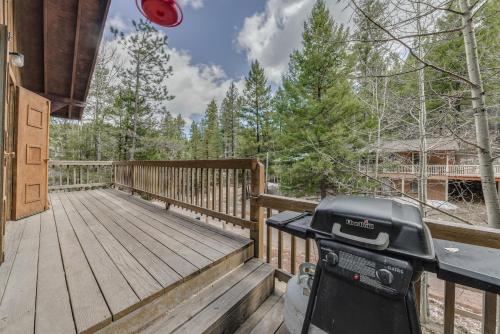 a grill on the deck of a house at Cloudcroft Cabin Vacation Rental 3 Mi to Skiing! in Cloudcroft