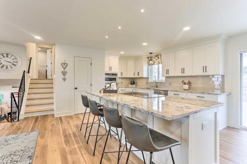 a kitchen with a large island with bar stools at 2 Mi to Dtwn Castle Rock Home with Furnished Patio in Castle Rock