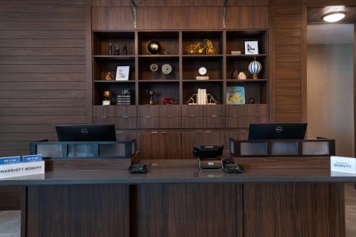 a reception desk with two laptops on top of it at Four Points by Sheraton Fort Worth North in Fort Worth