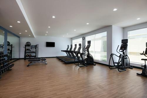 a gym with a bunch of treadmills and ellipticals at Four Points by Sheraton Fort Worth North in Fort Worth