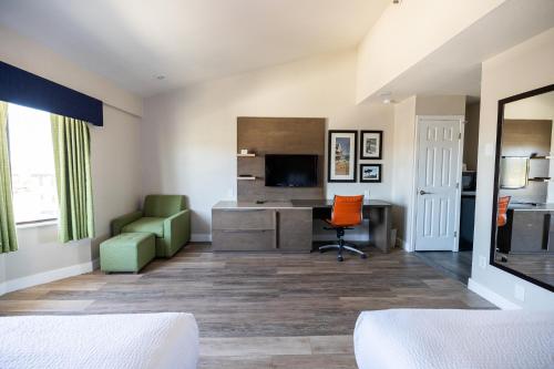 a hotel room with a desk and a chair at Days Inn by Wyndham Monterey Downtown in Monterey