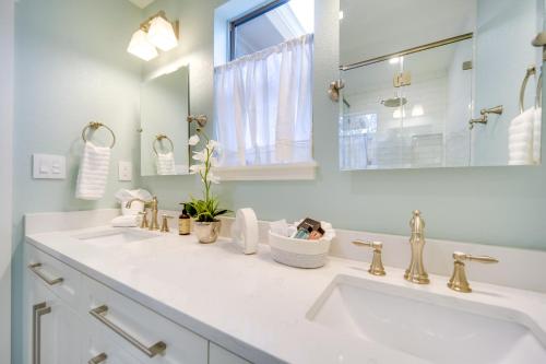 a white bathroom with two sinks and a mirror at Fredericksburg Home with Pool about 1 Mi to Main Street! in Fredericksburg